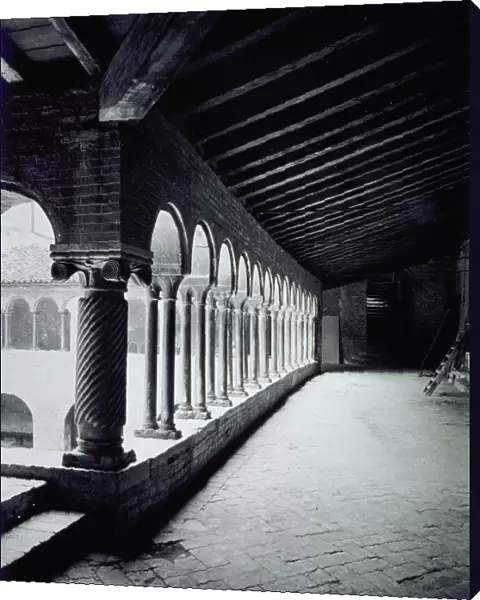 A part of the romanesque cloister of the Church of Santo Stefano in Bologna, with the characteristic coupled columns and the wooden rafter ceiling