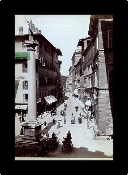 Peopled view of Via Tornabuoni in Florence