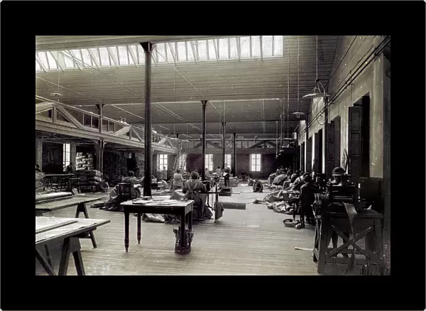 Interior room of the milanese plant of Tende Moretti, with the workers in charge of the sewing machines. In the room tables, lamps and fabrics to be worked can be seen