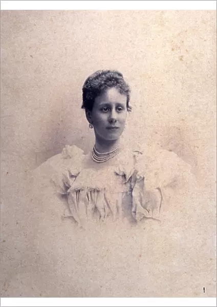 Half-length portrait of a lady in an elegant dress with bows and lace and a four string pearl necklace
