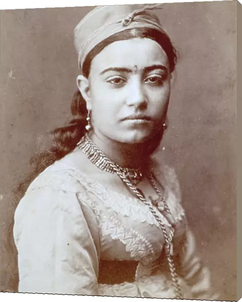 Half-length portait of an arab woman, she is wearing traditional dress and jewellery