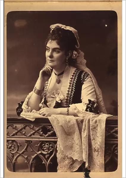 Portrait of a young woman in traditional clothing, leaning on a railing