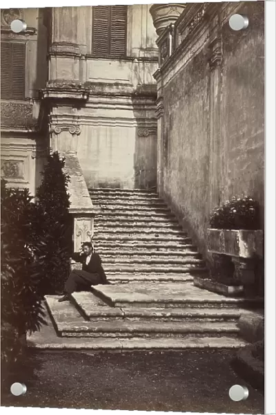 A man sleeps on the steps of the Casino del Bel Respiro steps inside Villa Doria Pamphilj in Rome. On the right an ancient sarcophagus used as a planter