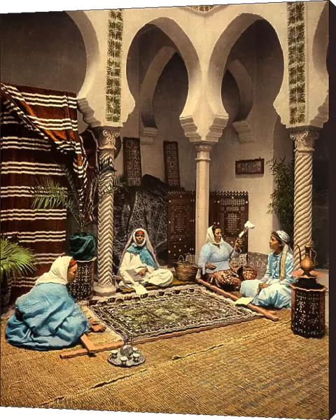 Arabian ladies weaving a Moorish carpet in an internal setting of Algiers