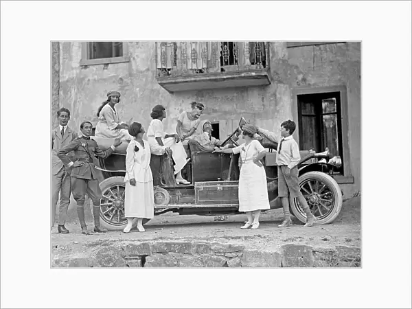 Group of young people posing next to a car