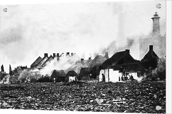 Some houses on fire, in Antewerp's outskirts, after the fall of the city under the German fire
