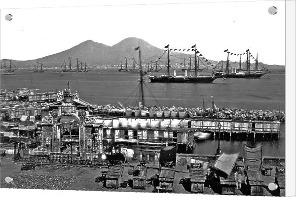 'S.Lucia. Naples'. The Gulf of Naples photographed from Via Partenope. In the foreground the Fountain of the Immacolatella and a few stands. In the background smoking Mount Vesuvious. Numerous ships are lying at anchor near the Port of Santa Lucia