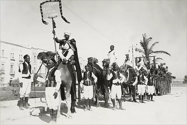 Bengasi: group of natives in traditional costume with camels