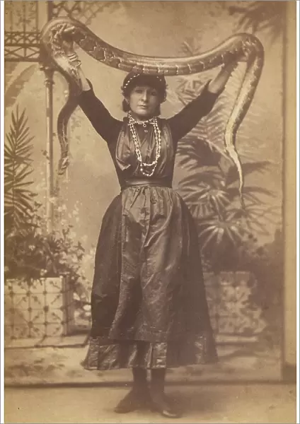 Portrait of a woman holding a boa constrictor above her head