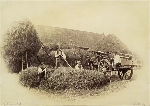 Farmers preparing bales of hay