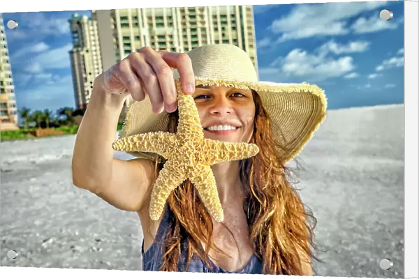 Florida, Marco Island, Beach, woman holding starfish