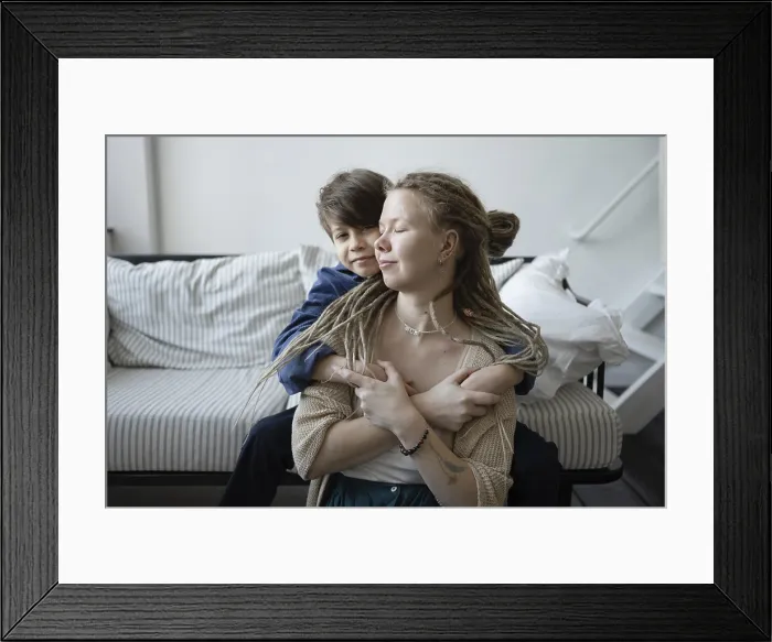 Framed Print : Mother and Son Embrace on Striped Sofa Print Framed Print : Mother and Son Embrace on Striped Sofa Print
