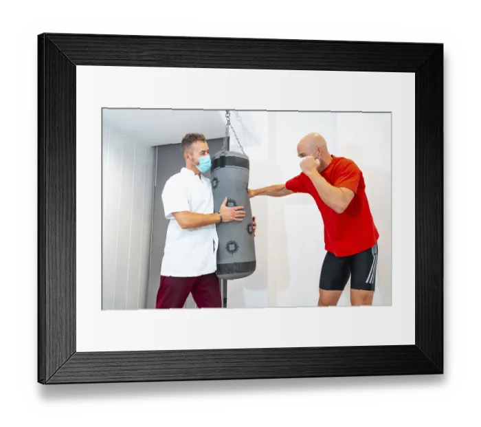 Framed Print : Physiotherapist and Patient on Punching Bag Print Framed Print : Physiotherapist and Patient on Punching Bag Print
