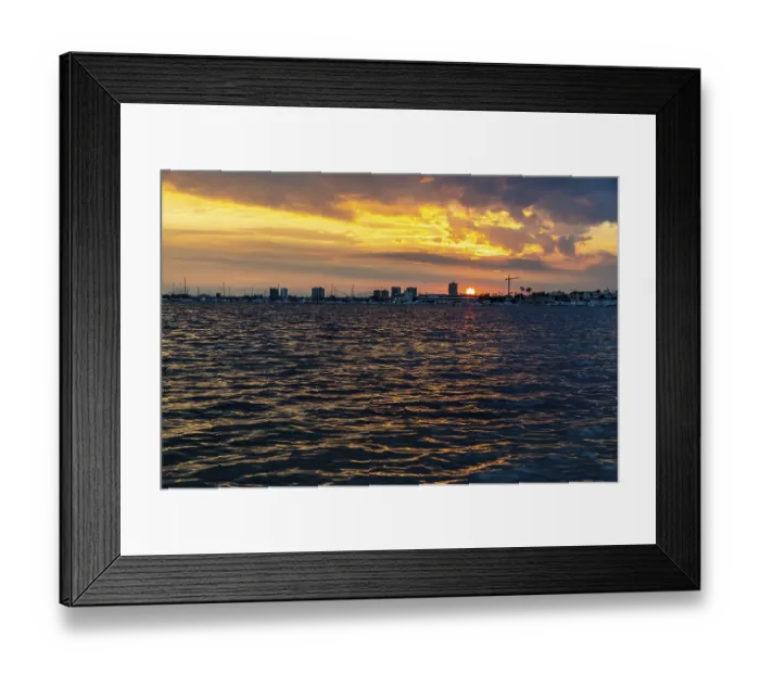 Framed Print : The sun sets over a calm coastal bay