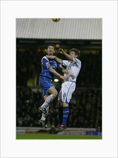 Dean Hammond challenges Oldhams Gary MacDonald in the air