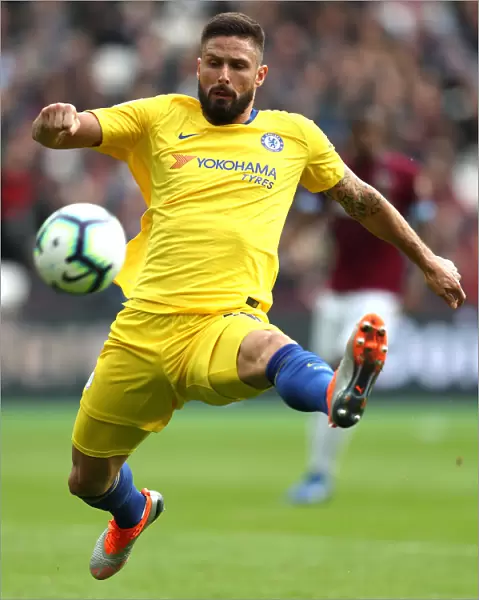 Chelsea's Olivier Giroud Reaches for the Ball in Intense West Ham Clash