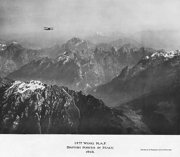 Biplane Flying over Snow-Covered Mountains 14th Wing Raf?