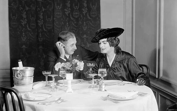 A couple having a champagne supper in America