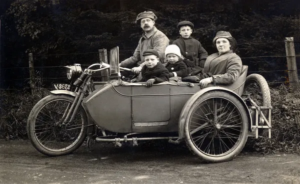 Family on a 1910 Harley Davidson motorcycle & sidecar