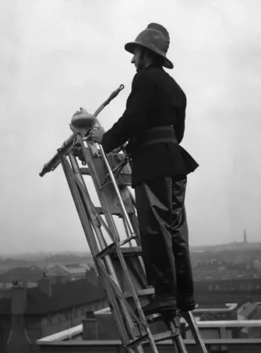 Framed Print : Firefighter using hook belt at top of ladder Print Framed Print : Firefighter using hook belt at top of ladder Print