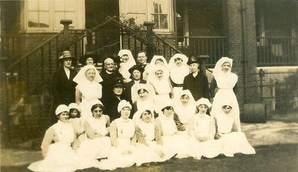 Formal group of nurses, older ladies, churchman
