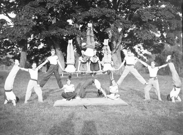Group of servicemen doing acrobatics in a field