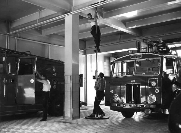 London firefighters sliding down a pole