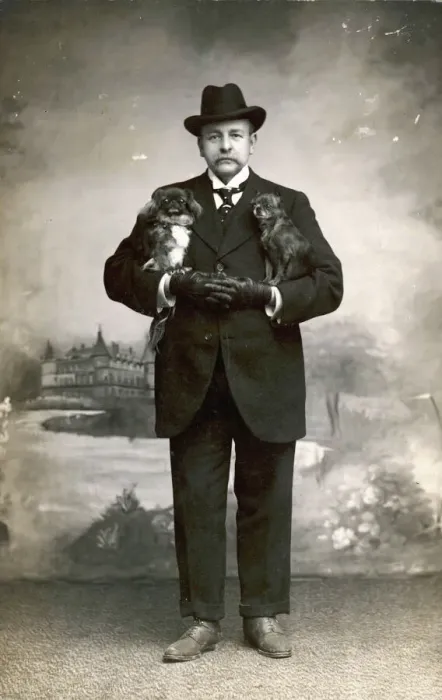 Framed Print : Man with Pekingese Print, a French man holding two dogs Framed Print : Man with Pekingese Print, a French man holding two dogs