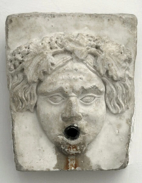 Marble fountain pipe. Dionysiac mask