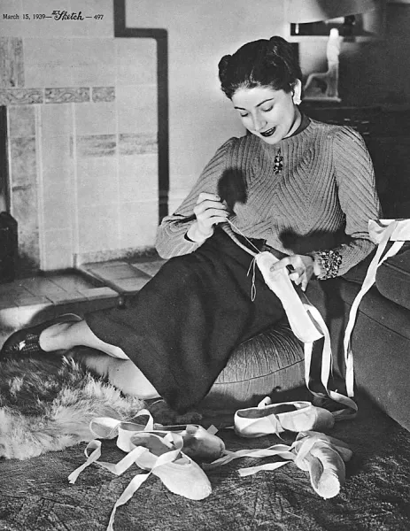 Margot Fonteyn repairing her ballet shoes