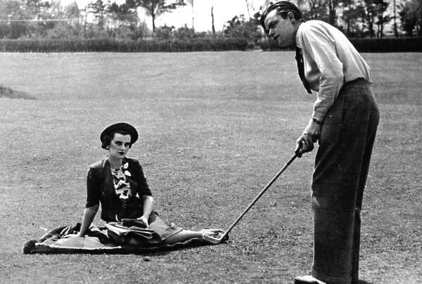 Mrs Charles Sweeny watching her husband play golf