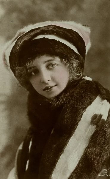 Pretty young woman in fur coat and hat