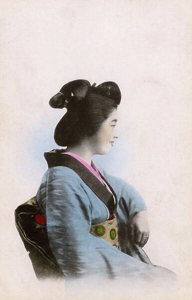 Profile portrait of a smiling Japanese Geisha girl
