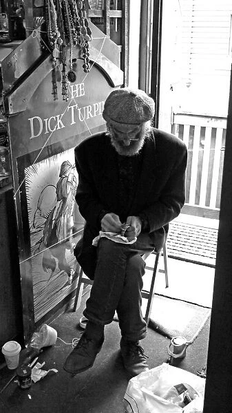 Seated artisan working on an object, England