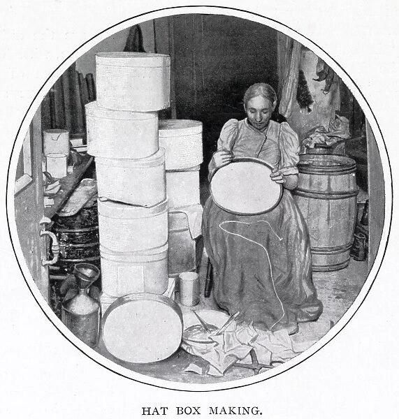 Woman sitting in her own home in South London, making the hat boxes for a supplier that