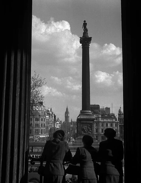 Women look out on Trafalgar Square, London
