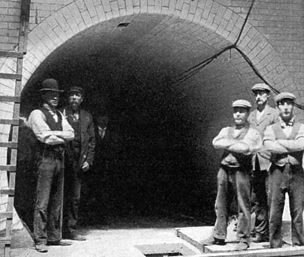 Workers outside the mouth of the Greenwich Foot Tunnel