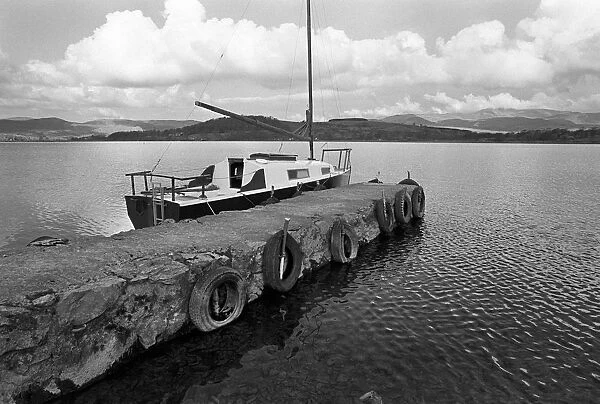 A yacht tied up to a pier on Bala Lake, Gwynedd. North Wales
