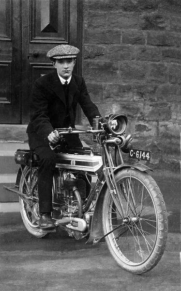 Young man on a 1910  /  14 Triumph motorcycle