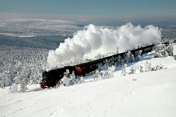 Small Gauge Steam Locomotive - riding through snow covered winter landscape - Brocken - National Park arz Mountains - Sachsen-Anhalt - Germany