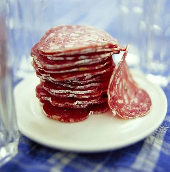 Salami slices on a plate. This food is a good source of protein