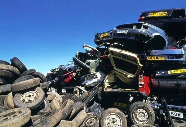 View of tyres and scrapped cars in a scrapyard