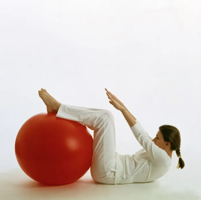 Framed Print : Woman using an exercise ball Print