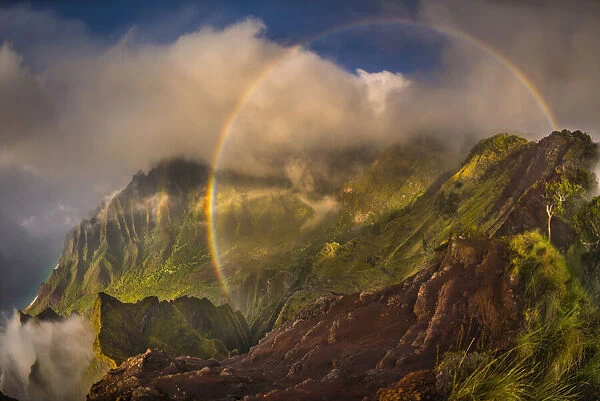 A 180 degree rainbow formed by the clouds over the Kalalau Valley on Kauai