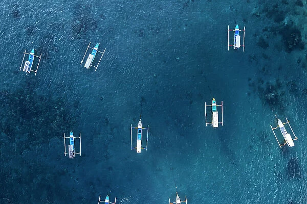 Aeria view of traditional empty fishing boats in the blue water of Gili Trawangan, Gili Islands, West Nusa Tenggara, Pacific Ocean, Indonesia, Southeast Asia Asia
