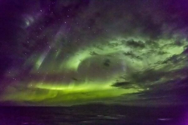 Aurora borealis (Northern Lights) dance above the Lindblad Expeditions ship National Geographic Explorer in Hudson Strait, Nunavut, Canada, North America