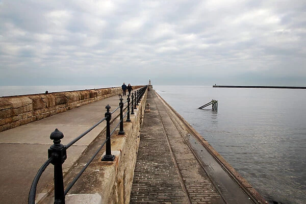 Couple walking on the North Pier at Tynemouth, North Tyneside, Tyne and Wear, England, United Kingdom, Europe