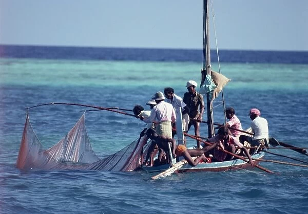 Crowded fishing boat raising its nets, Maldives For sale as Framed