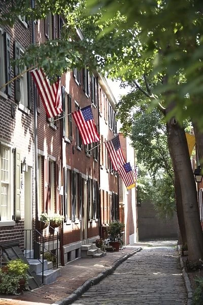 Flags displayed on homes on cobblestone American Street, in the Society Hill neighborhood of Philadelphia, Pennsylvania, United States of America