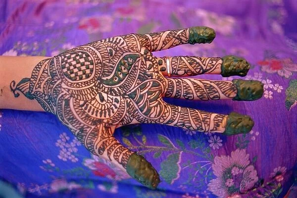 Hand decorated with design in henna